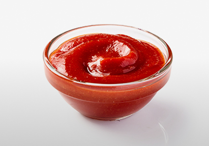 Chili sauce in a small glass dish.